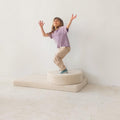 girl playing on boucle mattress and boucle pouf by bettys home, teddy boucle mattress for modern nursery