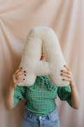 Boucle Letter cushion A by Bettys Home Teddy Letter Pillow held by woman in hand