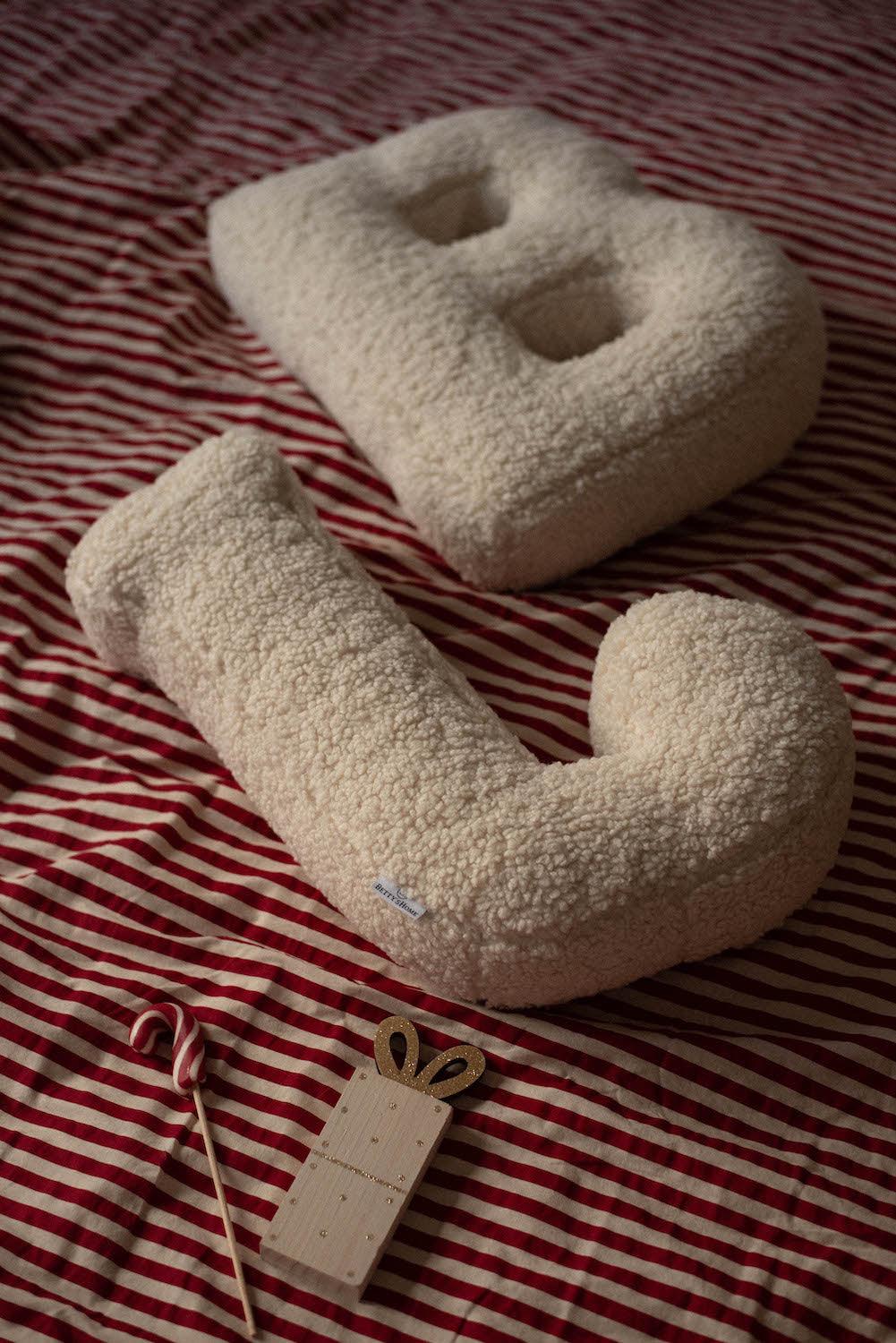Boucle Letter cushion B and J by Bettys Home Teddy Letter Pillow lying on bed as bedroom decoration idea