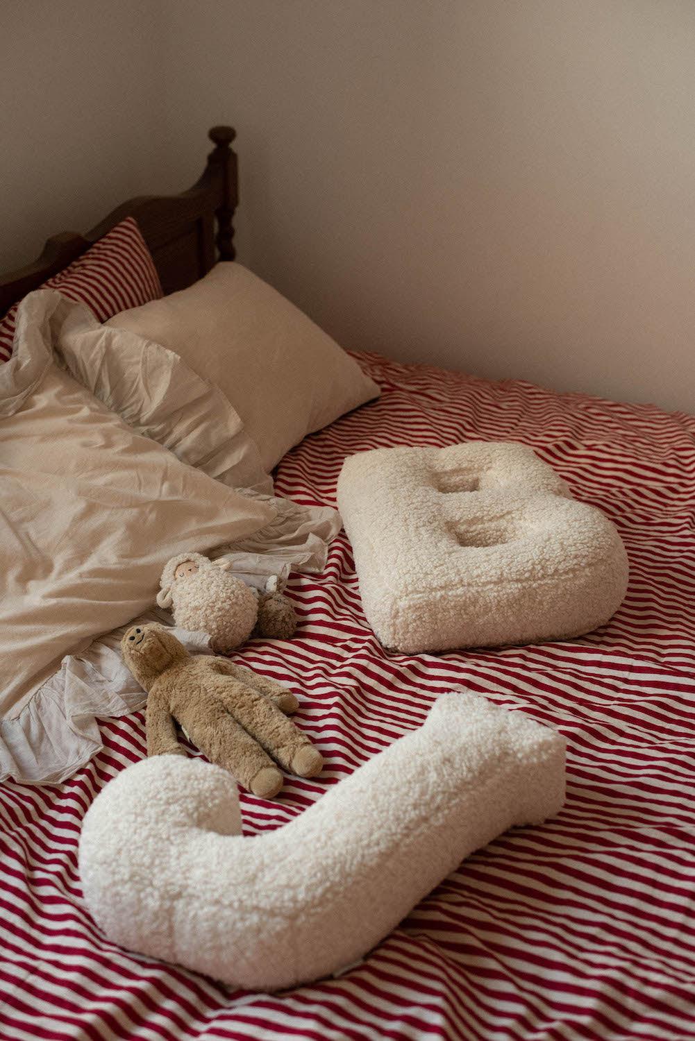 Boucle letter cushion J and B Teddy pillow by bettys home lying in bed as kids room decoration 