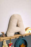 boucle letter cushion A teddy pillow by bettys home standing on shelf next to maileg mouse in kids room as deco idea
