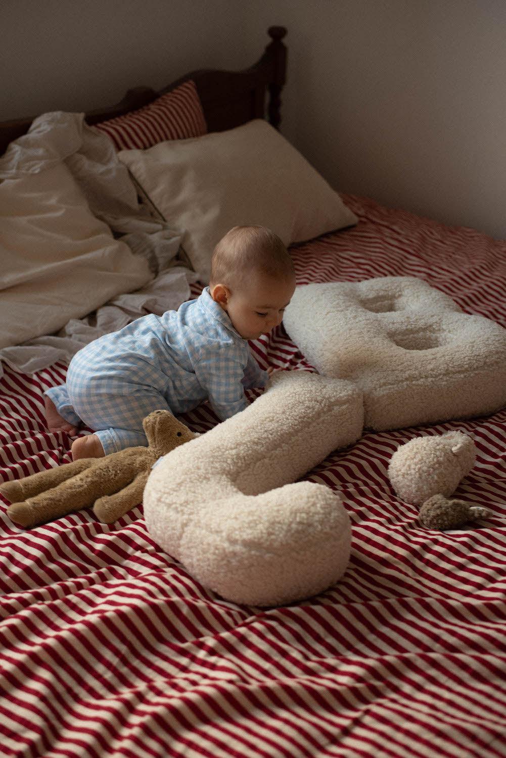 baby boy next to boucle letter cushion B and J teddy pillow by bettys home