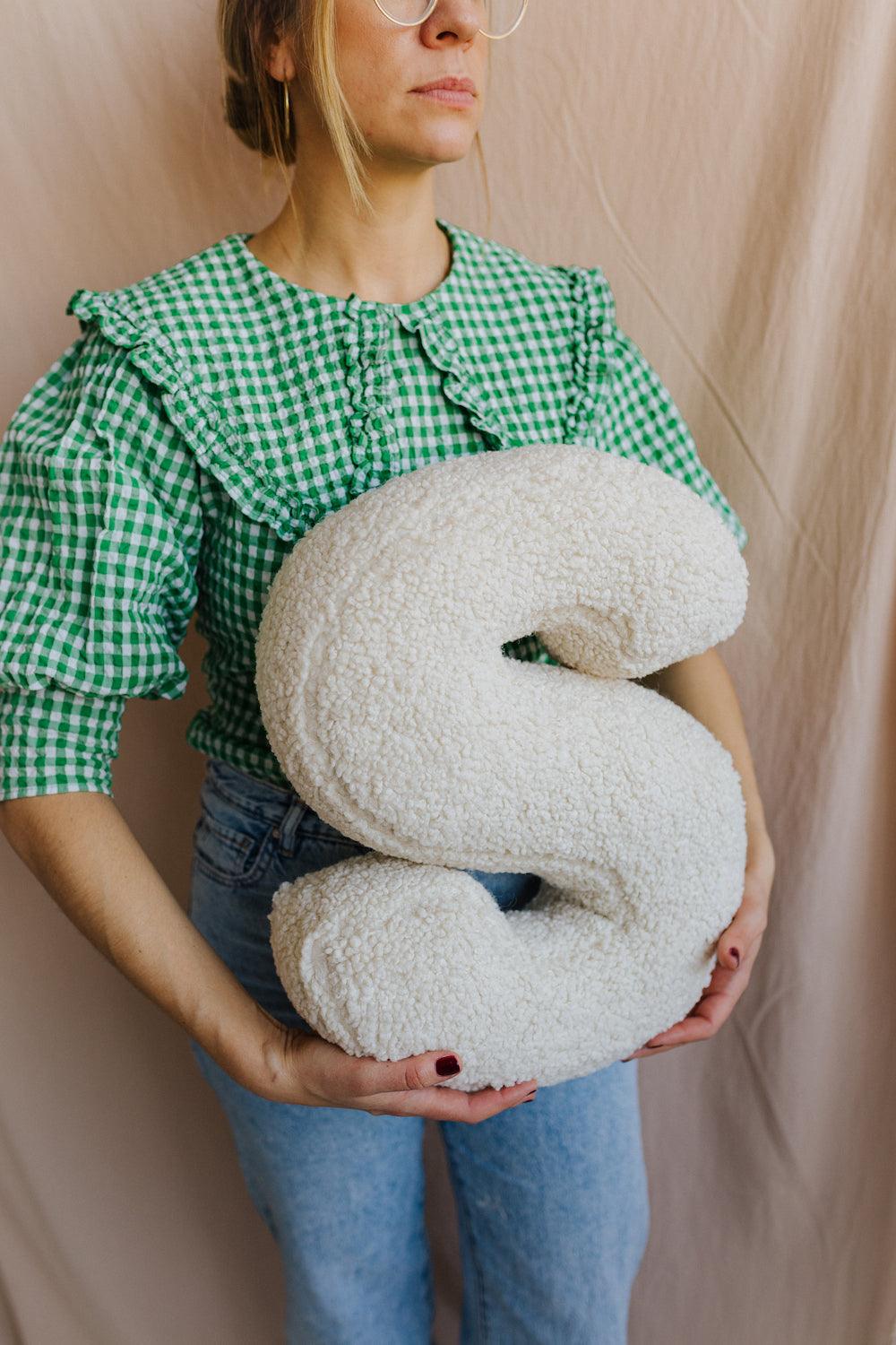 boucle letter cushion S teddy pillow by bettys home held by woman in green shirt baby gift idea