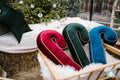 Christmas Candy cane cushion wine red by bettys home with green and navy candy cane cushions in front of christmas tree