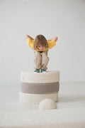 boy jumping of large boucle poufs by bettys home 2