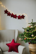 velvet star cushion wine red by bettys home on armchair next to christmas tree and christmas sack